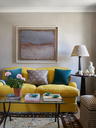 Image may contain Home Decor Cushion Lamp Couch Furniture Architecture Building Indoors Living Room and Room