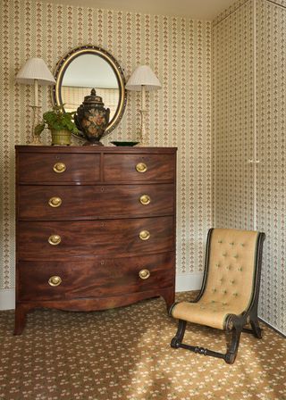 Image may contain Furniture Chair Lamp Plant Chest Of Drawers and Plate