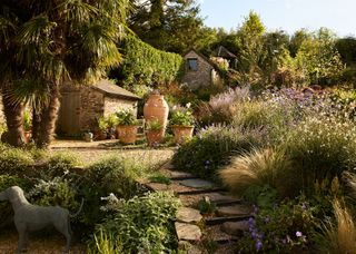 Image may contain Architecture Building Cottage House Housing Garden Nature Outdoors Backyard Yard and Plant