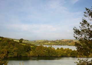 Image may contain Nature Outdoors Reservoir Water Scenery Boat Transportation Vehicle Plant and Vegetation