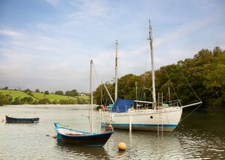 Image may contain Boat Sailboat Transportation Vehicle Water Waterfront Watercraft Yacht Nature and Outdoors
